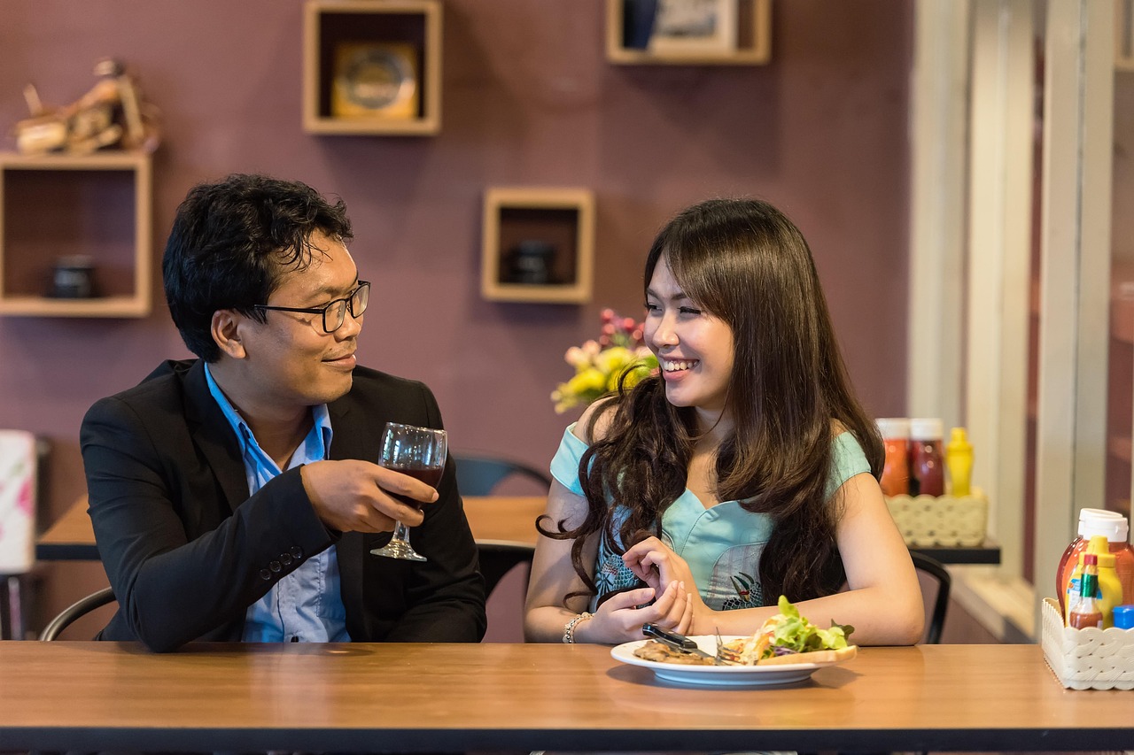Two diners sharing a meal across a restaurant table